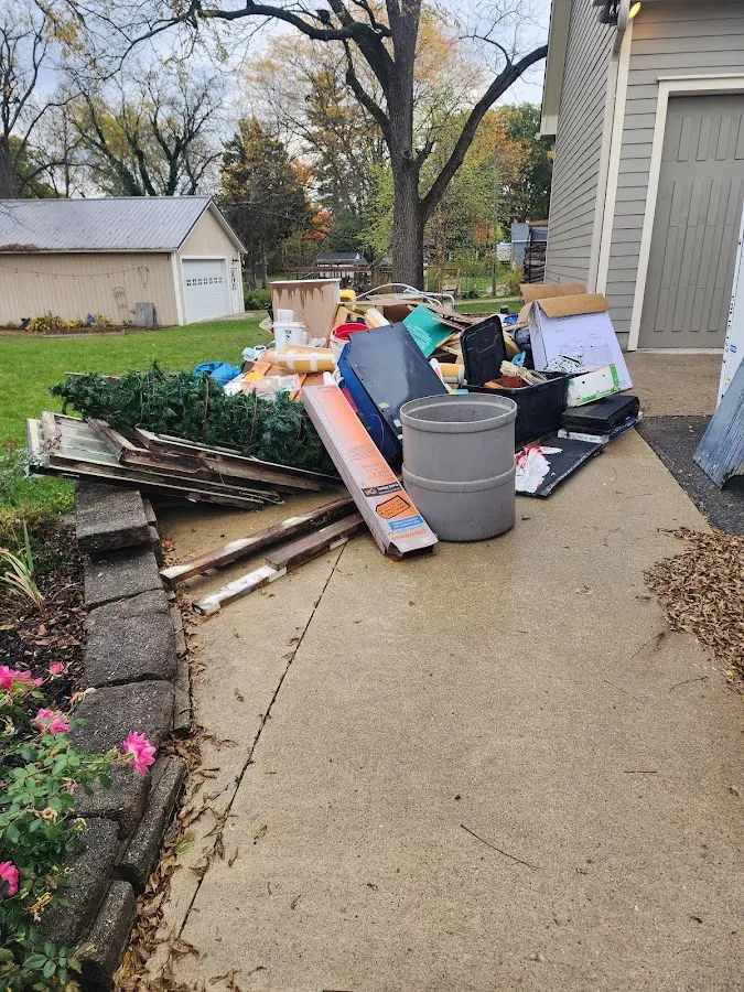 Dumpster being loaded with debris for Estate Cleanout Dumpster Rental in Shenandoah Farms